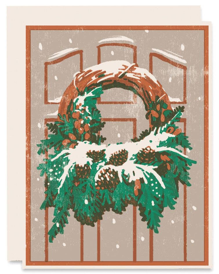 Christmas card with a snowy wreath on a door