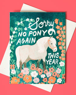 A colorful greeting card with an illustration of a pony in a flower meadow, accompanied by the text 'Sorry no PONY again this YEAR' in a vibrant, teal-colored font. The card also includes a white envelope and is blank inside.