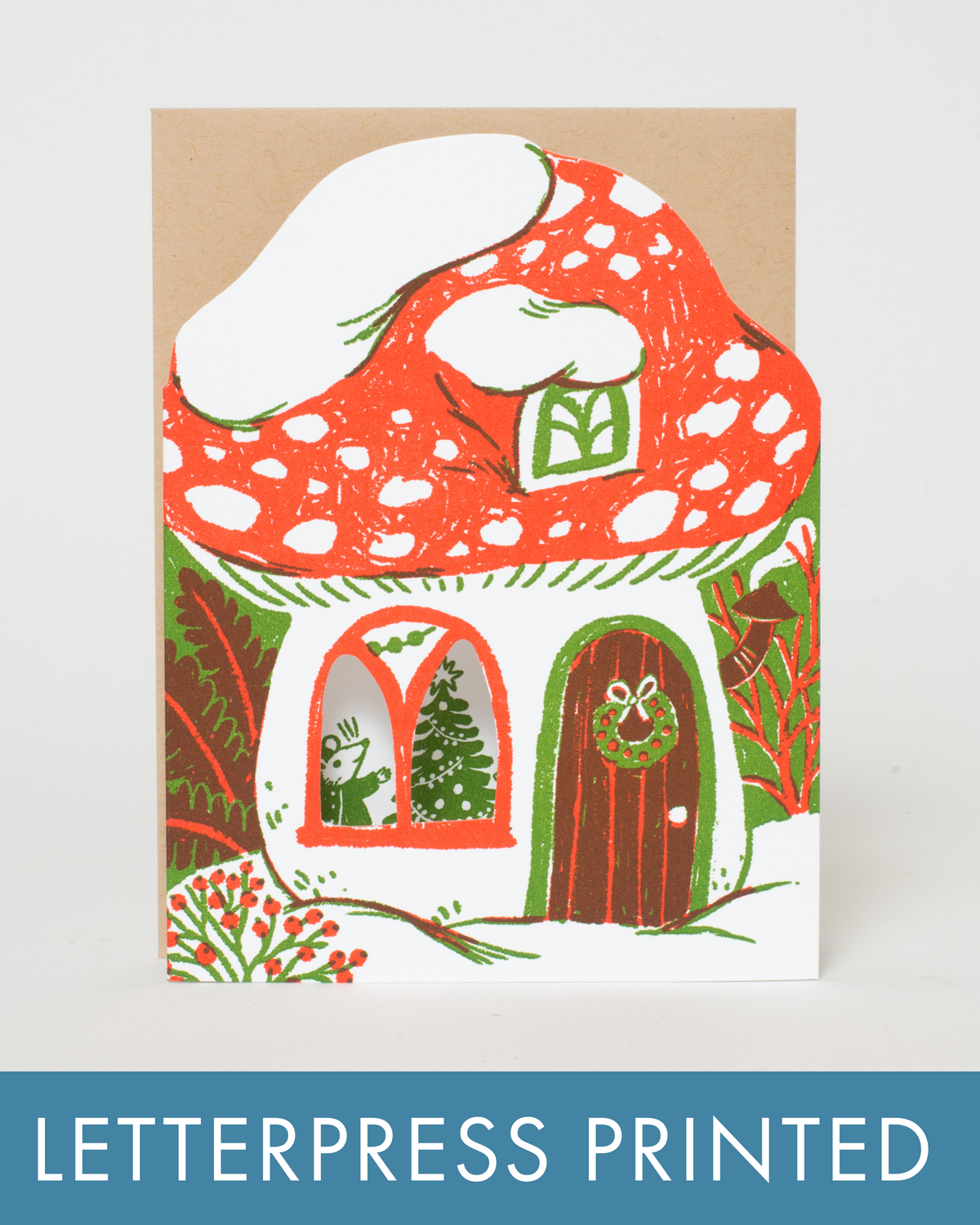 Letterpress printed card with a mushroom house design on a white background