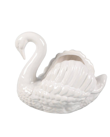 White ceramic swan on a white background
