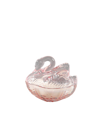 Pink glass swan candle on a white background