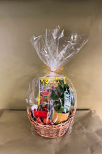 Gift basket wrapped in clear cellophane with a green paper background