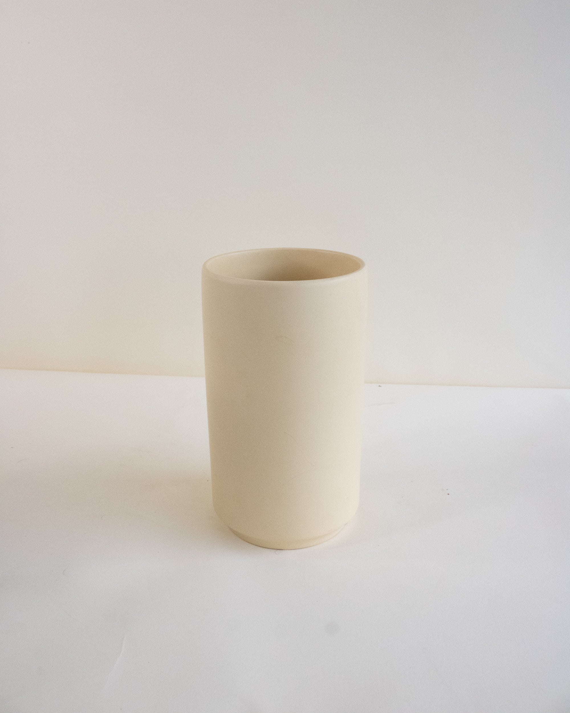 Cream ceramic vase on a white background