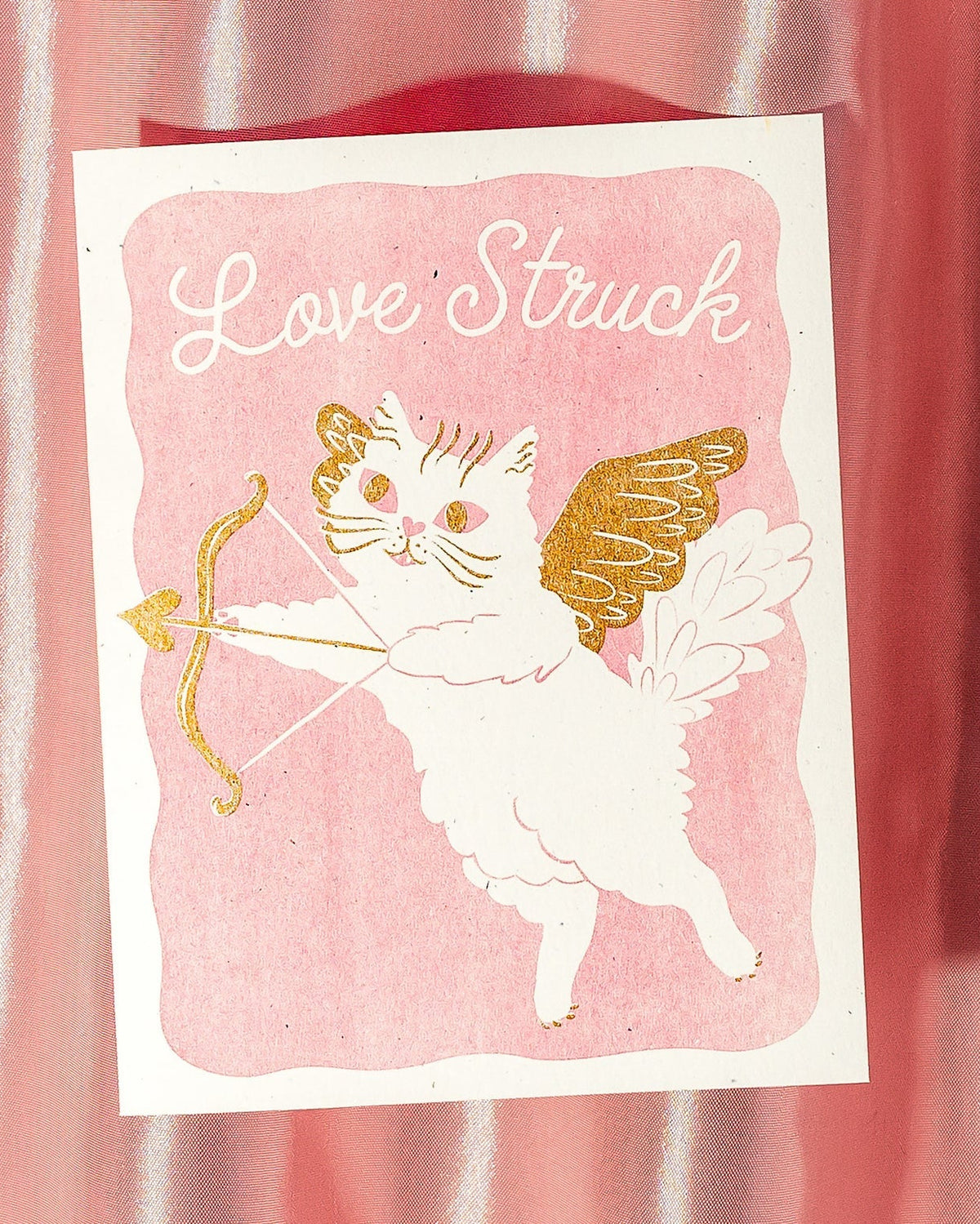 Card with a cat Cupid illustration and 'Love Struck' text on a pink background