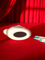 White swan match holder on a red background