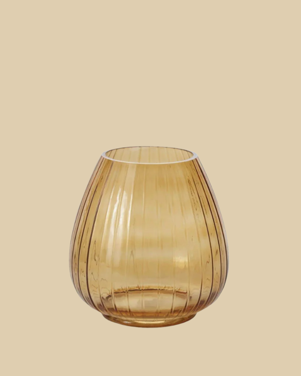 amber glass vase on plain peach backdrop