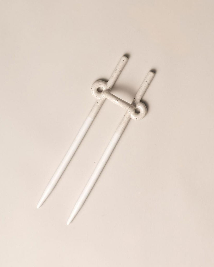 White ceramic plant stake on a beige background