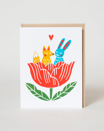 Illustration of a fox and a rabbit sitting inside a red flower with green leaves on a white background.